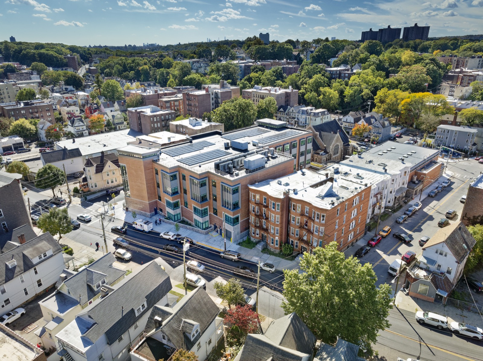 Aerial view of a four-story brick school building in a residential neighborhood